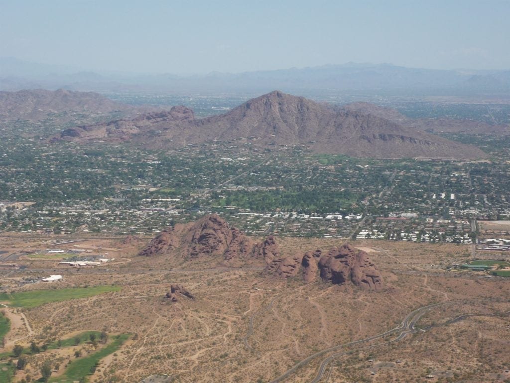 camelback mountain is dark red in coloe an is in the shape of a sleeping camel