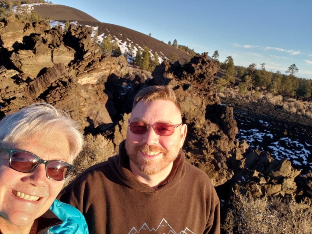 Unstoppable Stacey stands with husband Dan in front of volcanic lava field