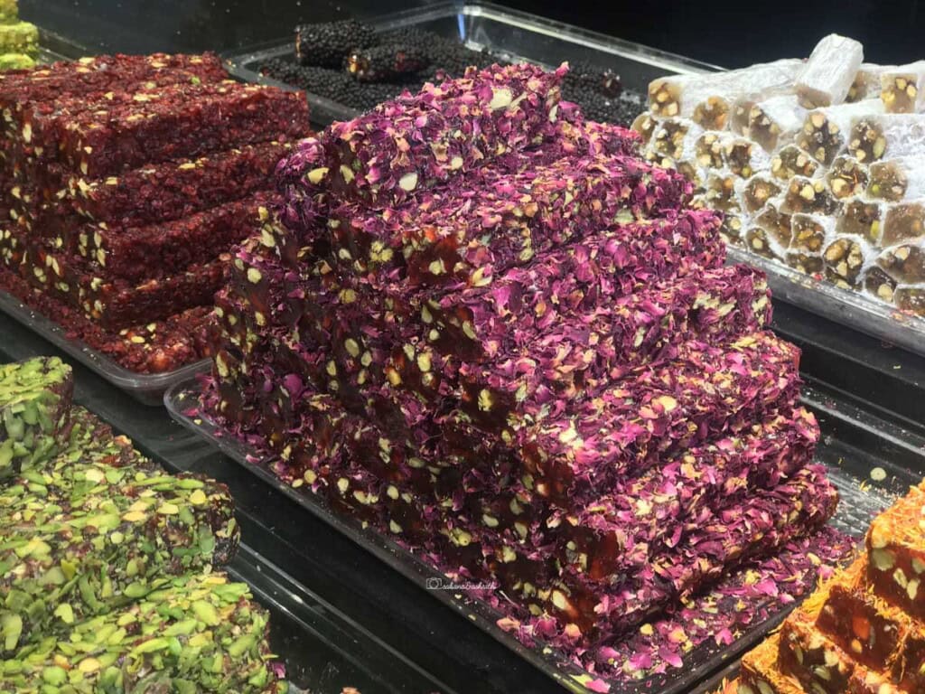 Rose petal coated magenta coloursweet bars colcalled Turkish delight stacked in a shop at Istanbul Grand Bazar