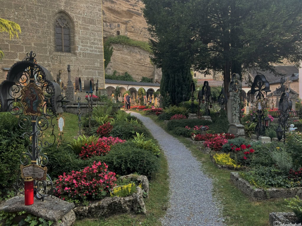 Beautiful cemetery with iron cross and flower garden in salzburg