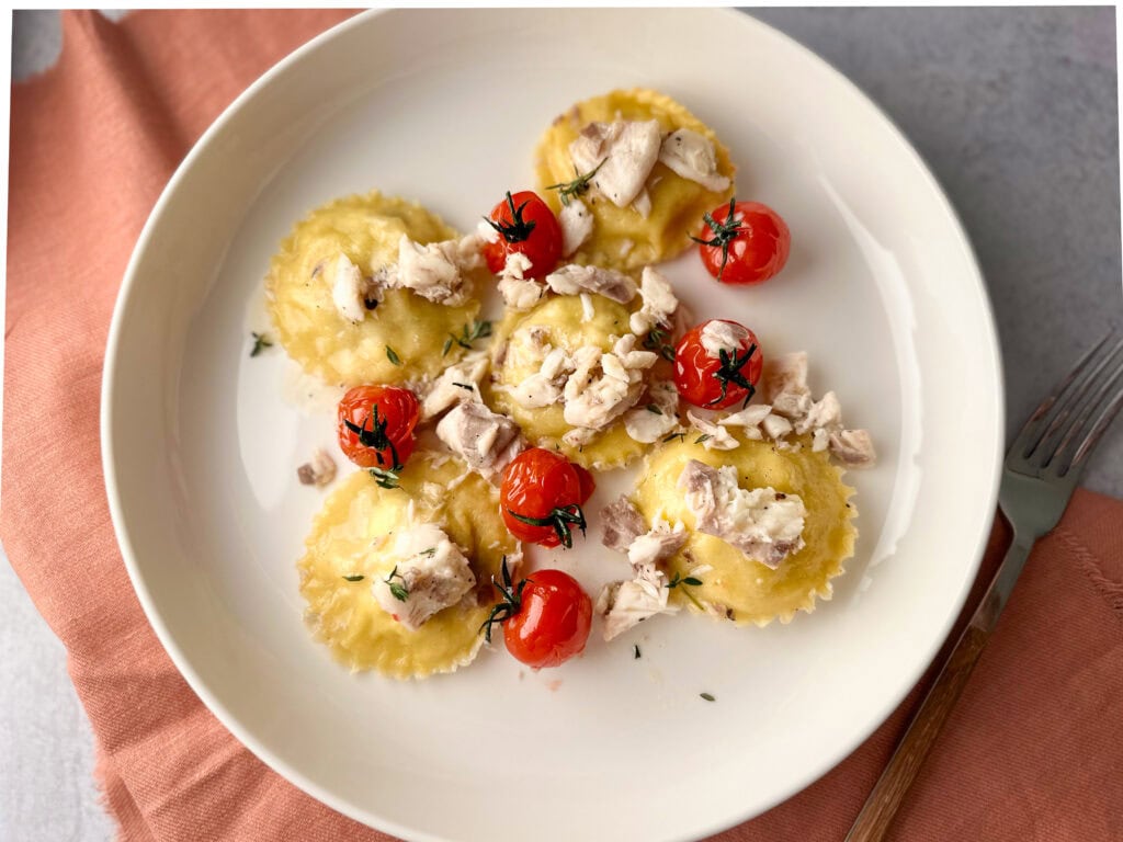 Homemade Sea Bass ravioli plated on a white plate.