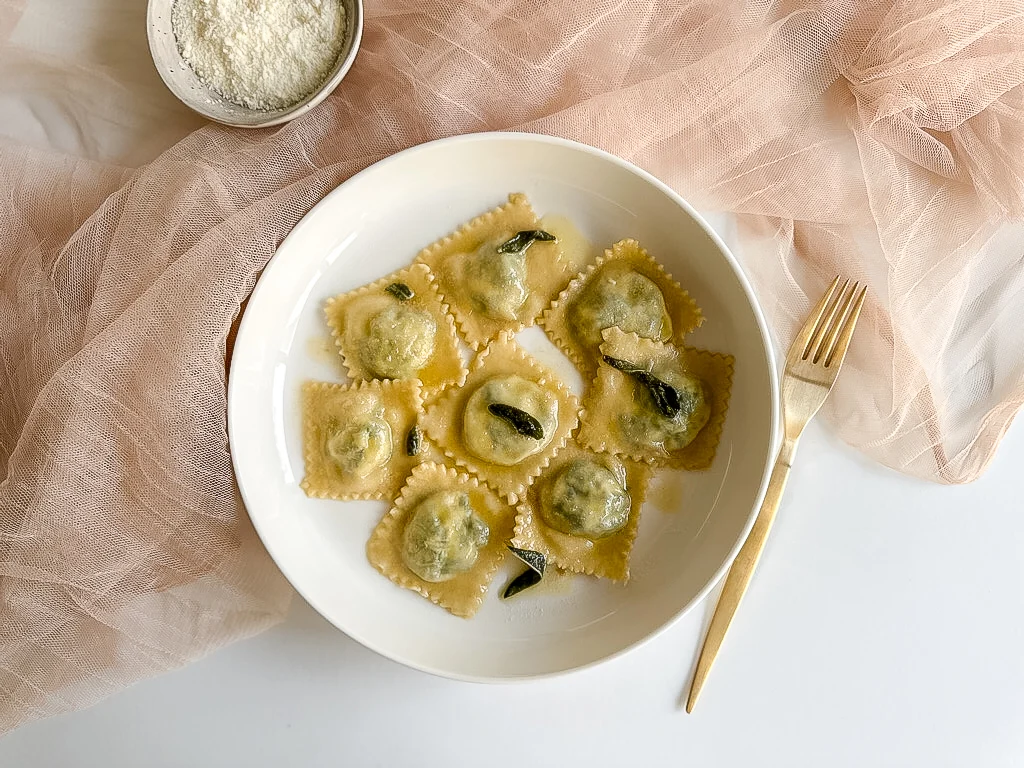 Plate of ravioli with butter and sage sauce