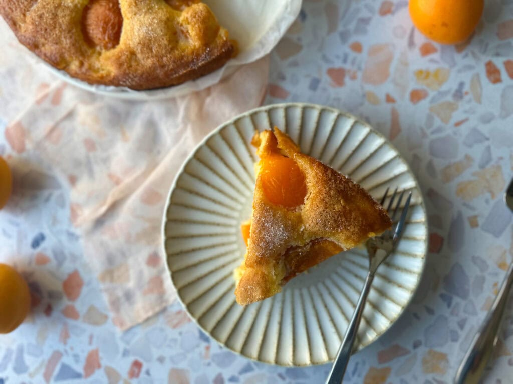 Apricot cake on a plate with a fork