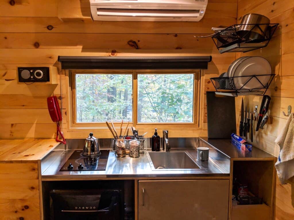 Kitchenette inside Postcard Cabins Shenandoah with stove and fridge