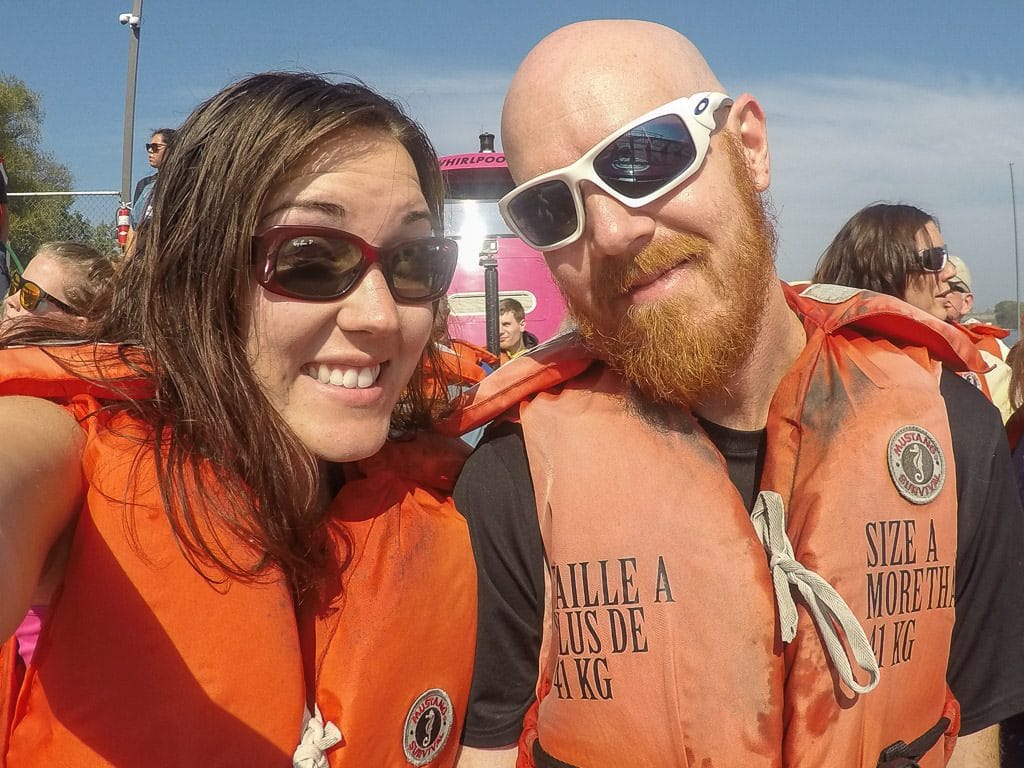 Brooke and Buddy posing on the jet boat before their whirlpool jet boat tour at Niagara Falls