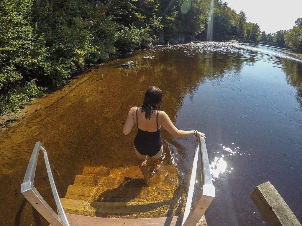 Brooke walking down the stairs into the Diable River at scandinave spa in mont-tremblant