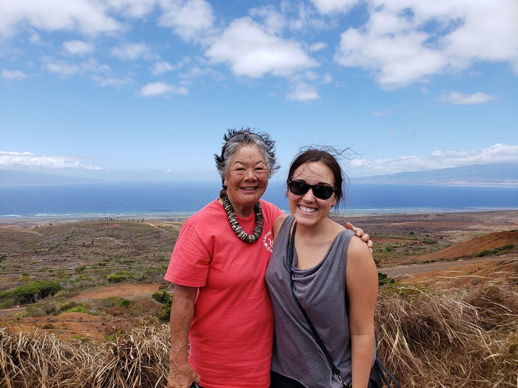 photo with tour guide on lanai tour with island views behind