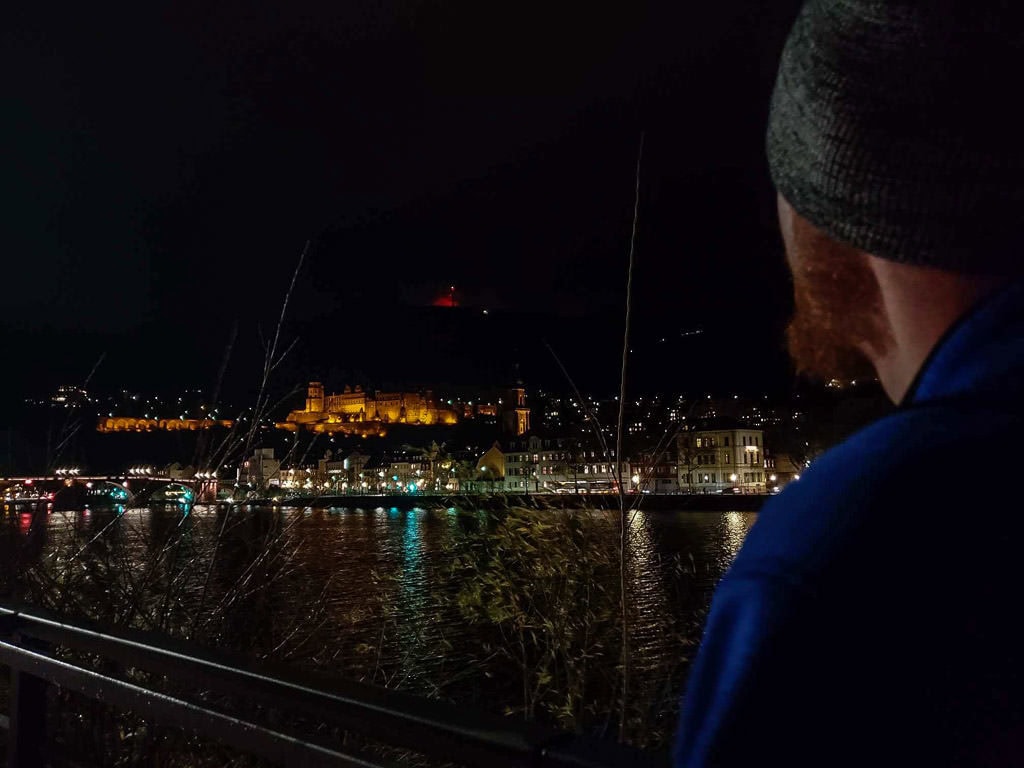 looking at night views of heidelberg castle germany from river