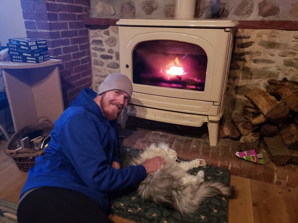 cuddling a cat in front of a fire during an international house sitting gig in France