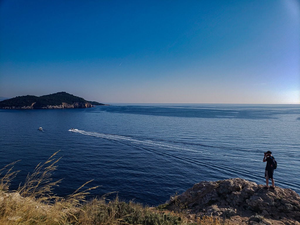 Buddy taking a photo on the edge of a cliff next to the Adriatic Sea