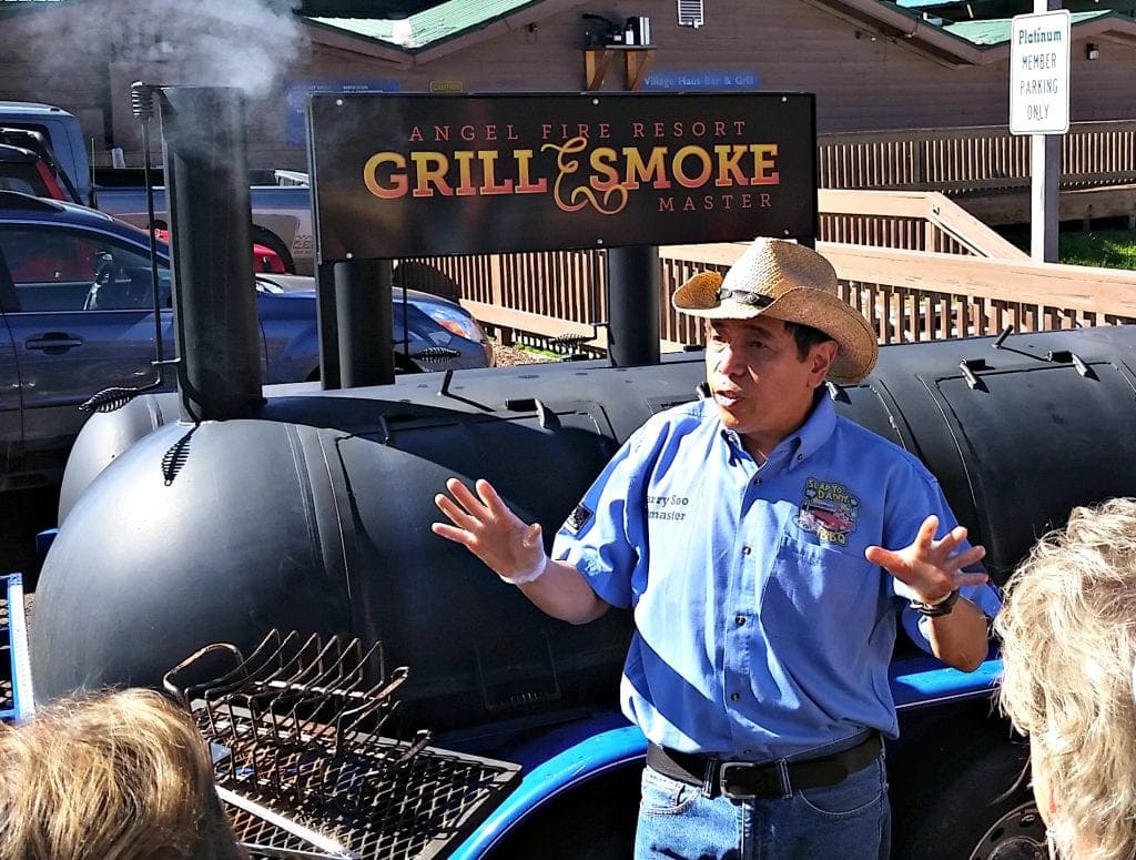 Celebrity Chef Harry Soo stands in front of BBQ grill at Angel Fire Food and Wine Roundup