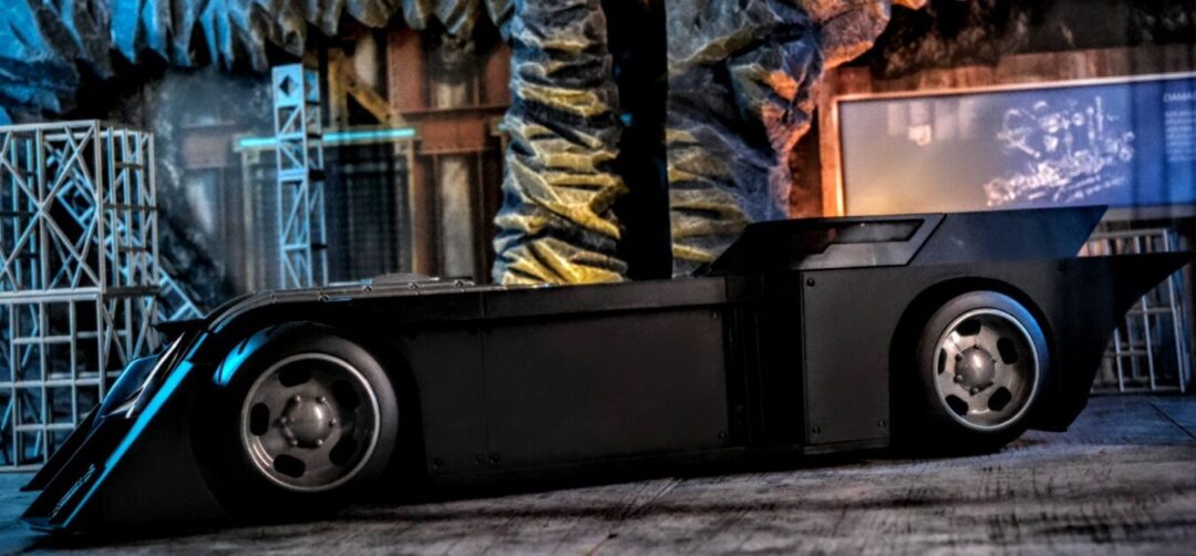 Side profile of McFarlane Toys DC Rebirth Batmobile in Batcave setup.