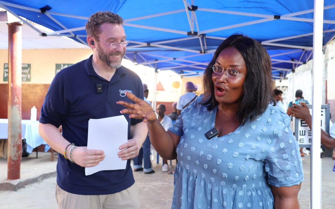 Beneficiary Mercy, pictured with GVUSA Executive Director Matt Gianino, enthusiastically shows off her new GoodVision glasses.