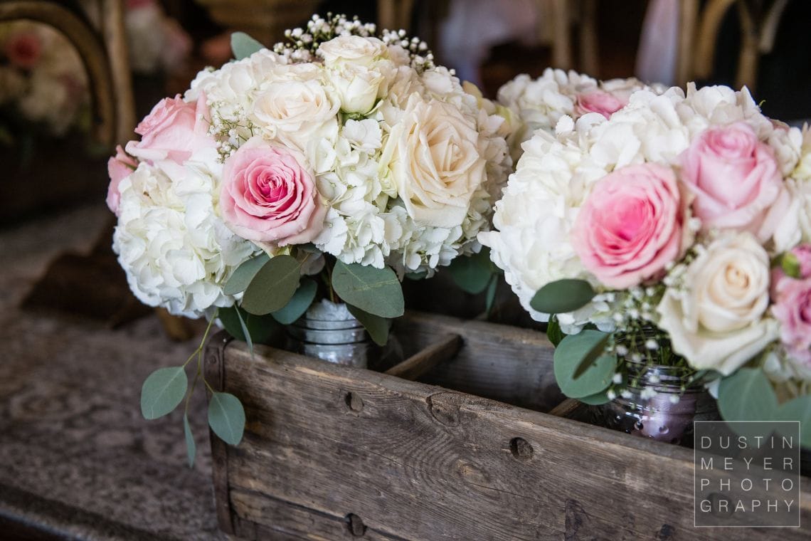 A colorful bridal bouquet along with stunning floral designs throughout the wedding.