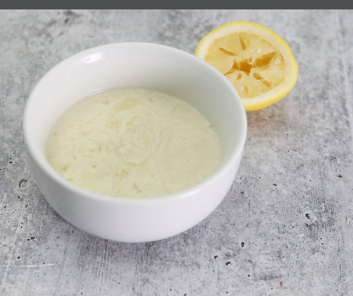 curdled milk for vegan butter in a white bowl with lemon