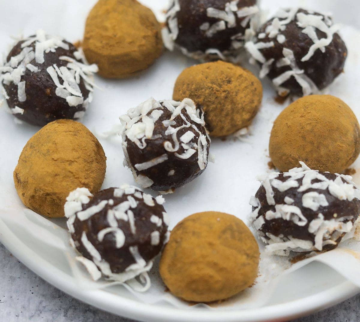 carob truffles in a white plate, close up view