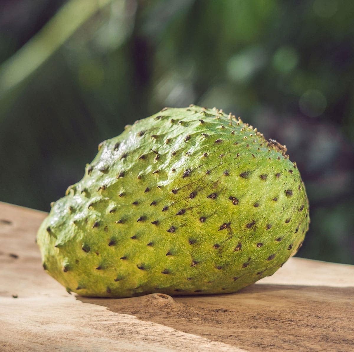 whole soursop on a wooden background