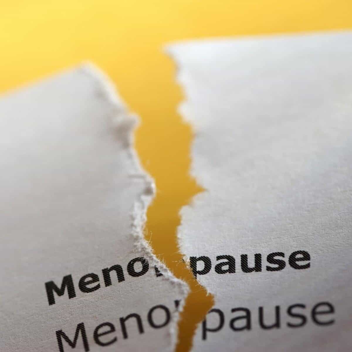 menopause on typed paper torn down the middle with yellow background