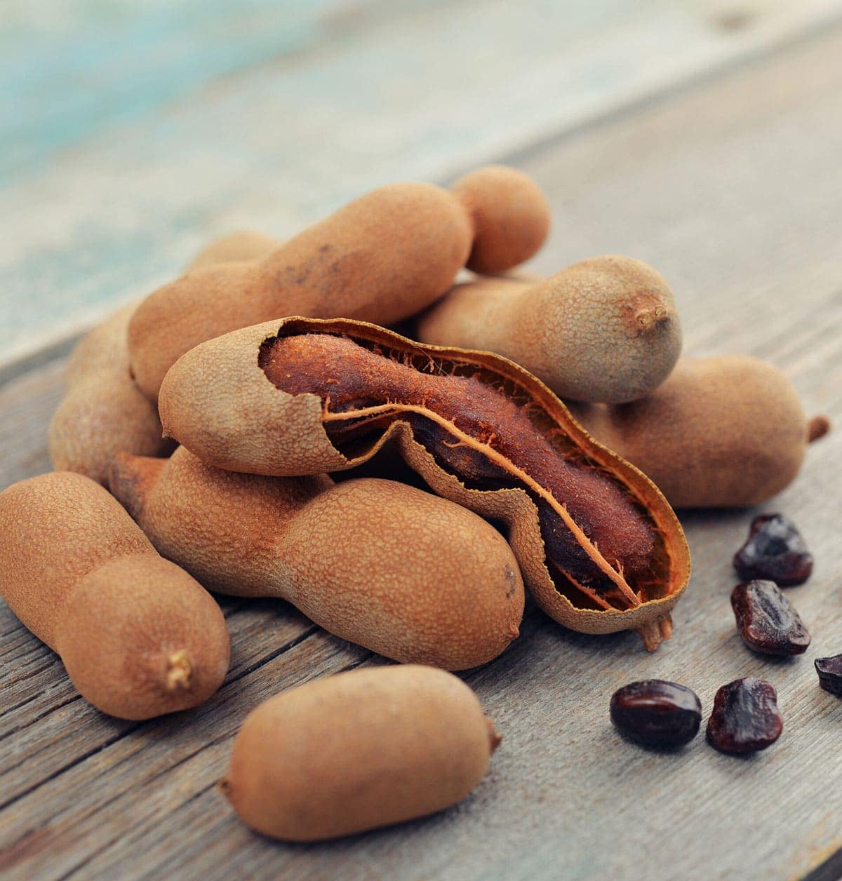tamarind pods on a wooden background