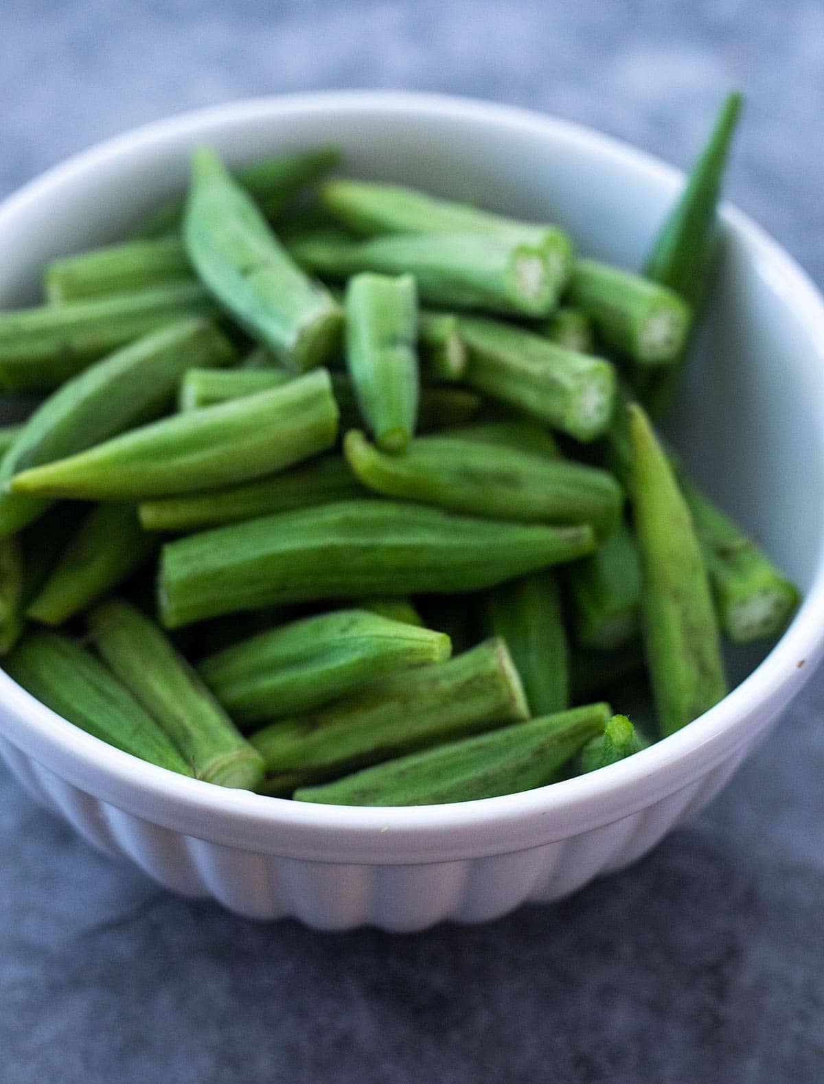 Okra in a white bowl for making okra fries