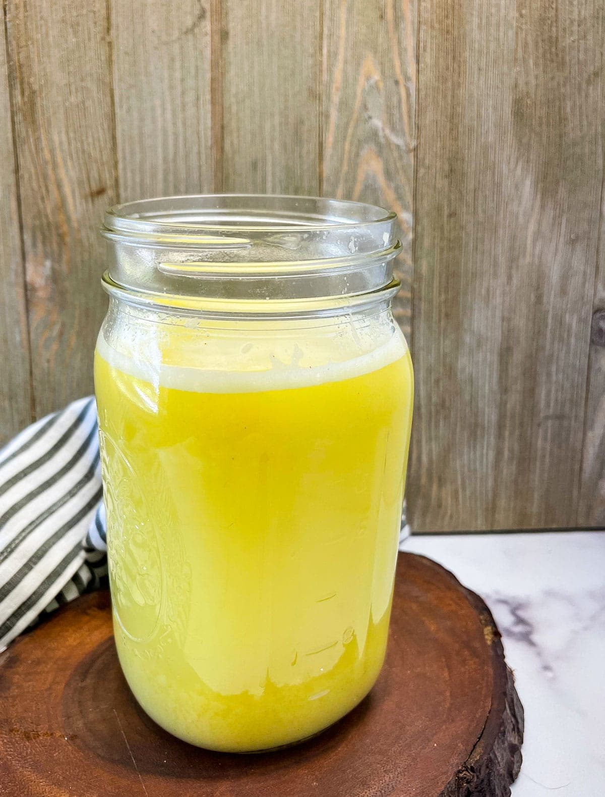 star fruit juice close in a glass jar on a wooden background