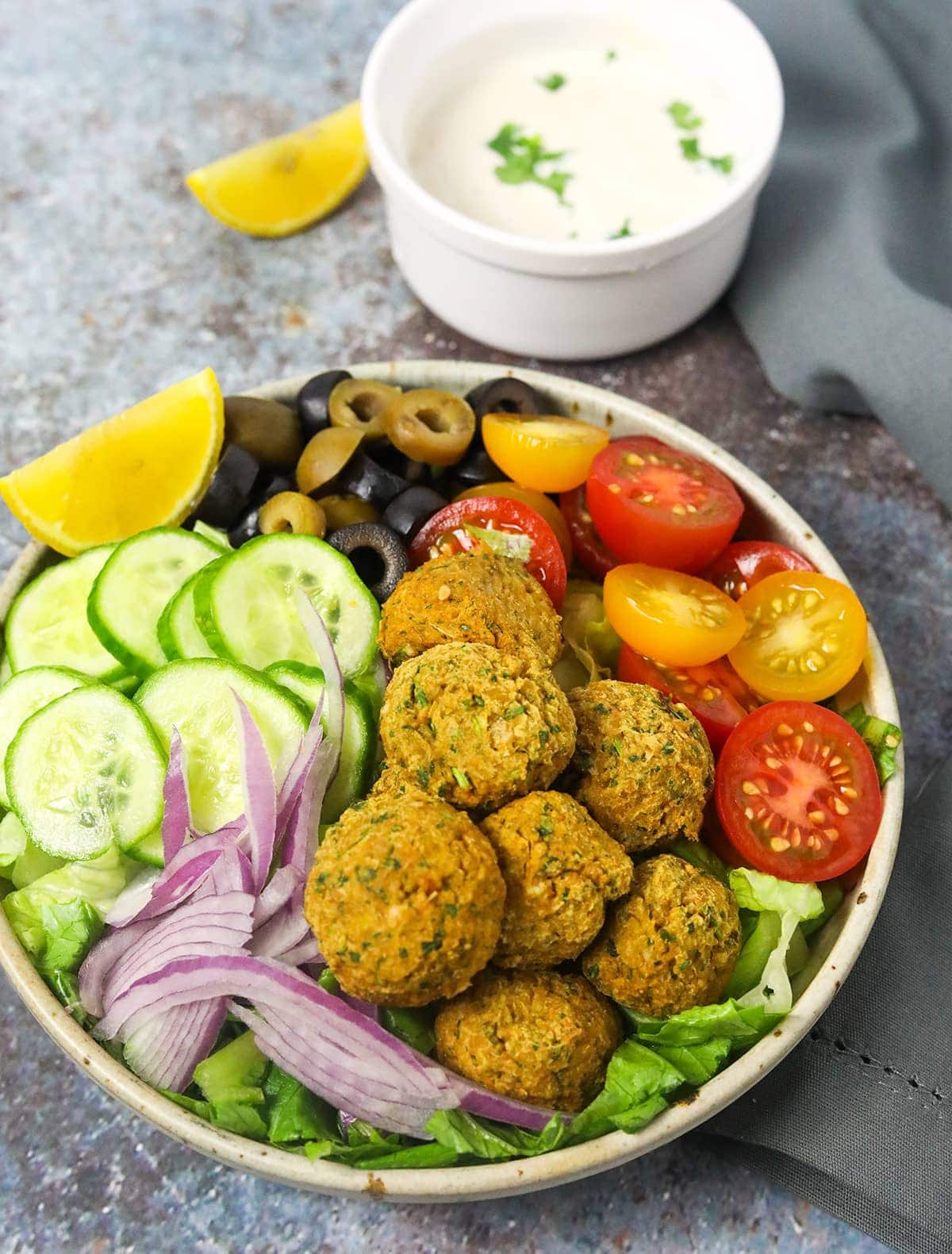 Enjoy this easy recipe for Air Fryer Falafel Bowl is so delicious and hearty, falafel, served on a bed of chopped lettuce with red onion, tomato, olives, cucumber.
