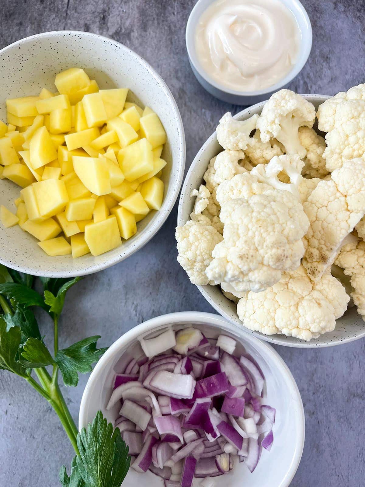 cauliflower potato salad ingredients with red onion and mayo