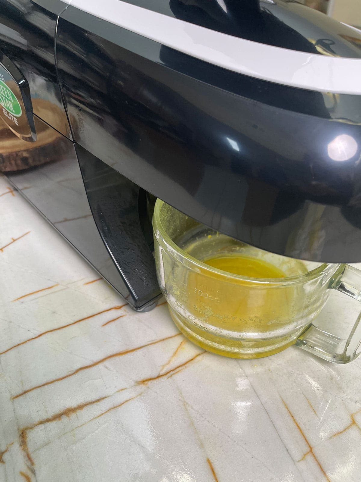 ginger turmeric shot being juiced in juicer