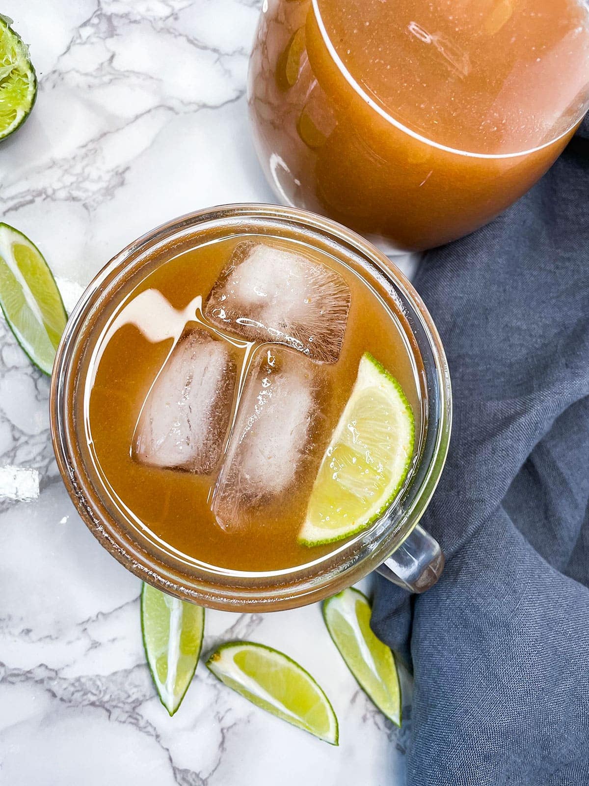 tamarind juice drink recipe in glass with ice overlay