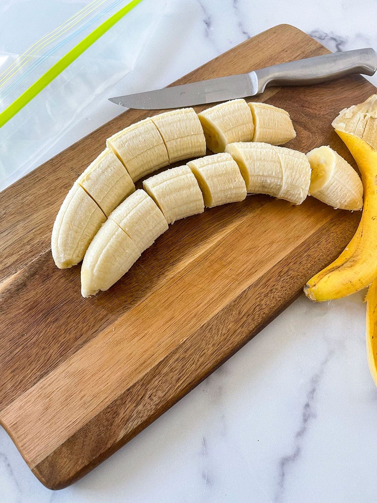 Peel bananas cut into slices on a wooden cutting board