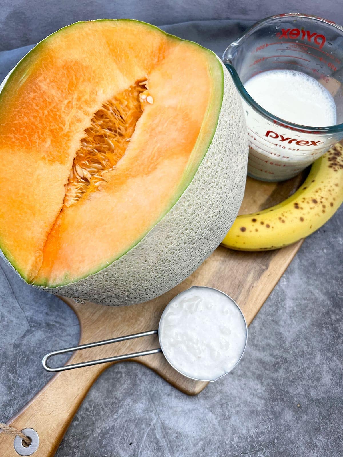 cantaloupe smoothie ingredients on cutting board