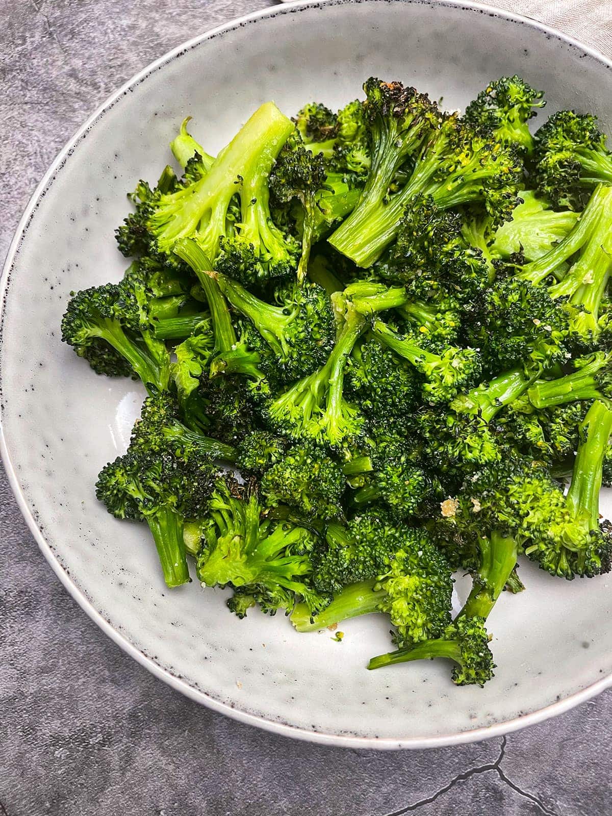 air fried broccoli on a white plate