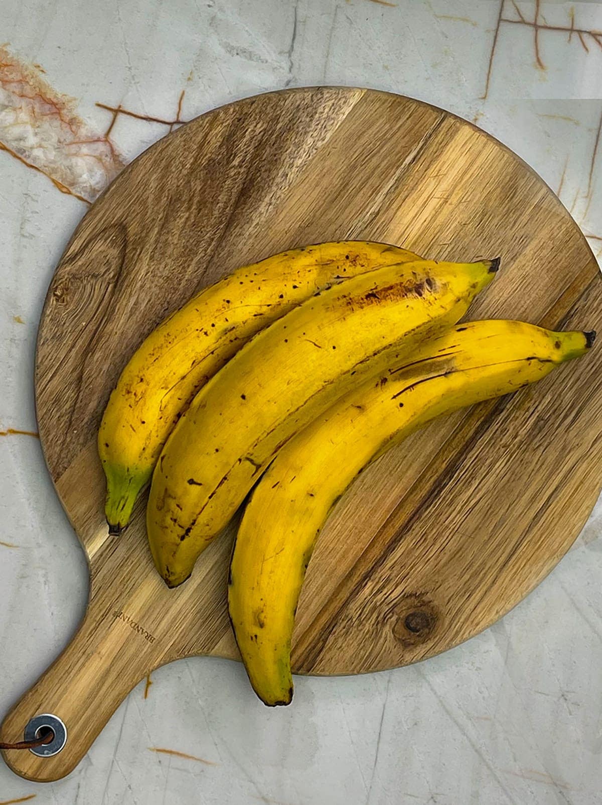 whole ripe plantains on cutting boad