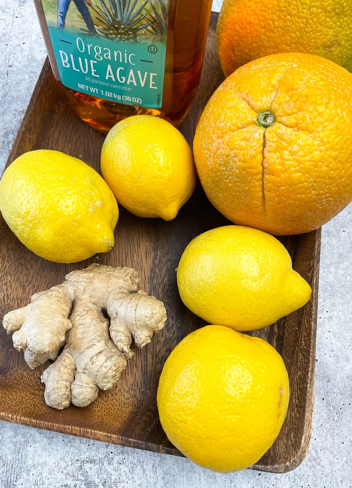 Orange lemonade ingredients, lemons, oranges, ginger, agave, water