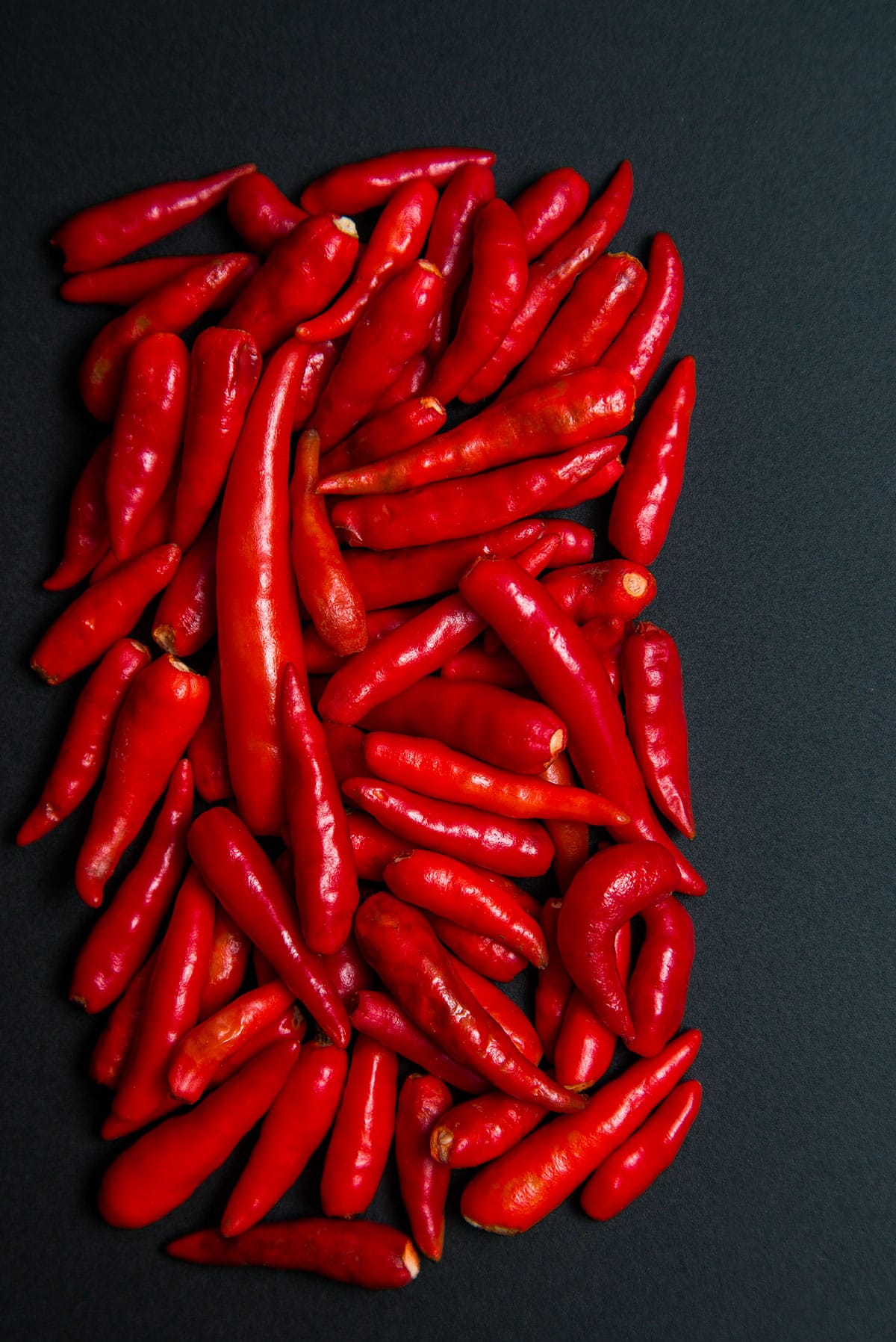 African bird peppers on a black background