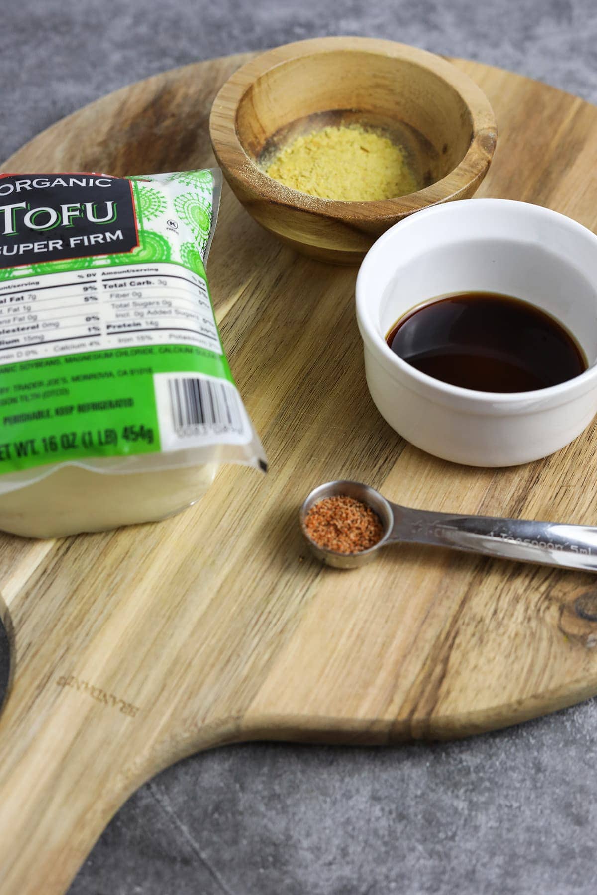 tofu crumble ingredients on a wooden cutting board