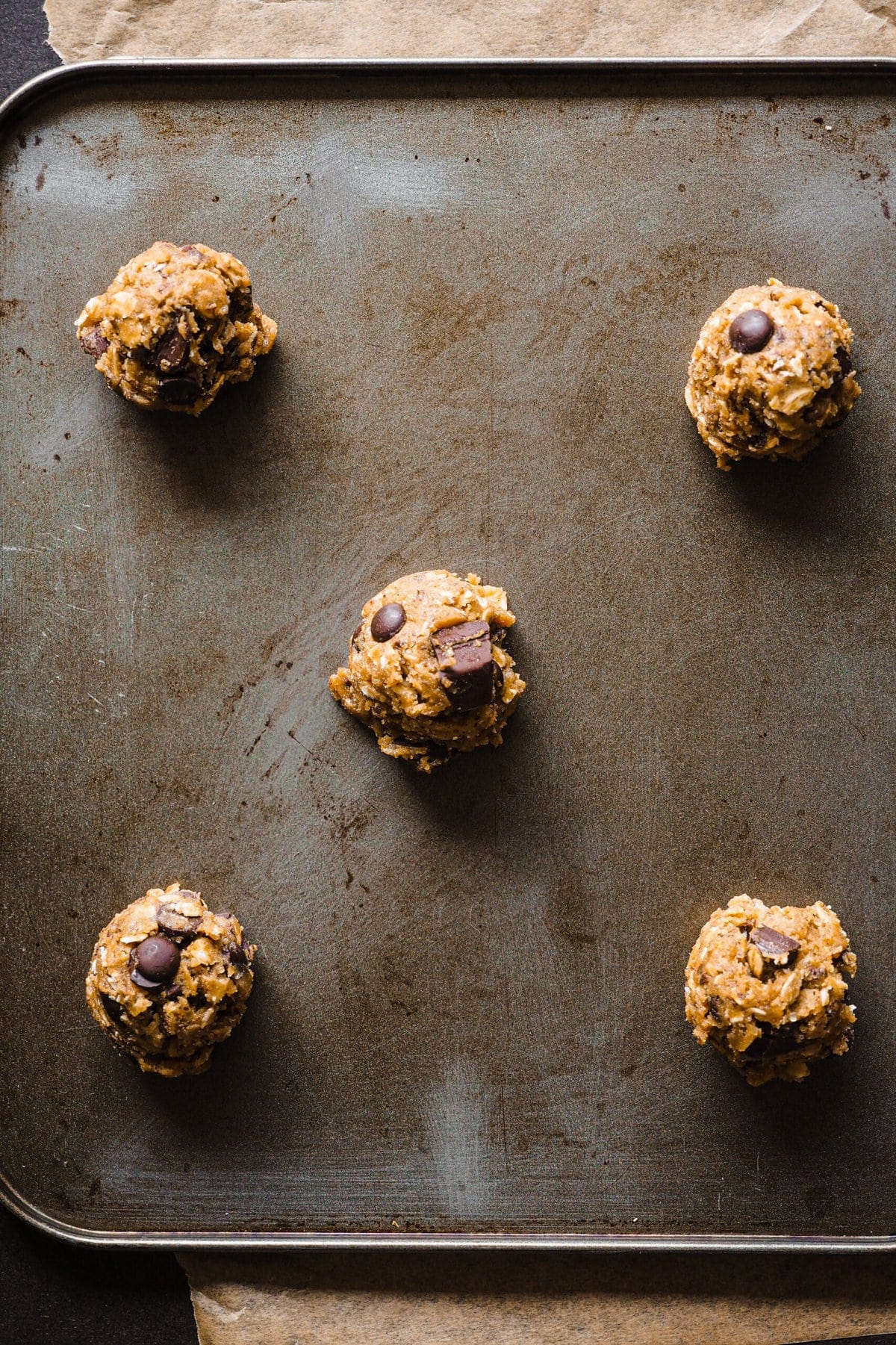 Brown Butter Oatmeal Chocolate Chip Cookies dough balls on a baking tray. | Paula's Apron Recipe