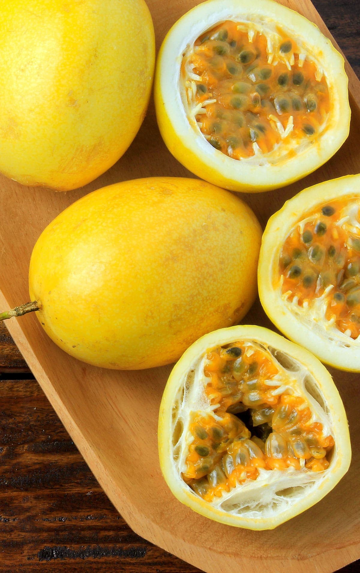 Passion fruit on a cutting board, some af