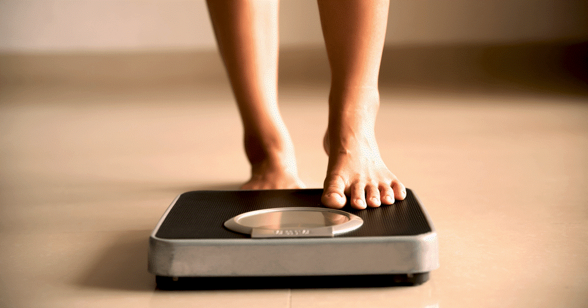 A person step on the weight scale