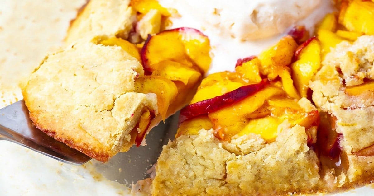vegan peach galette, a slice being taken out