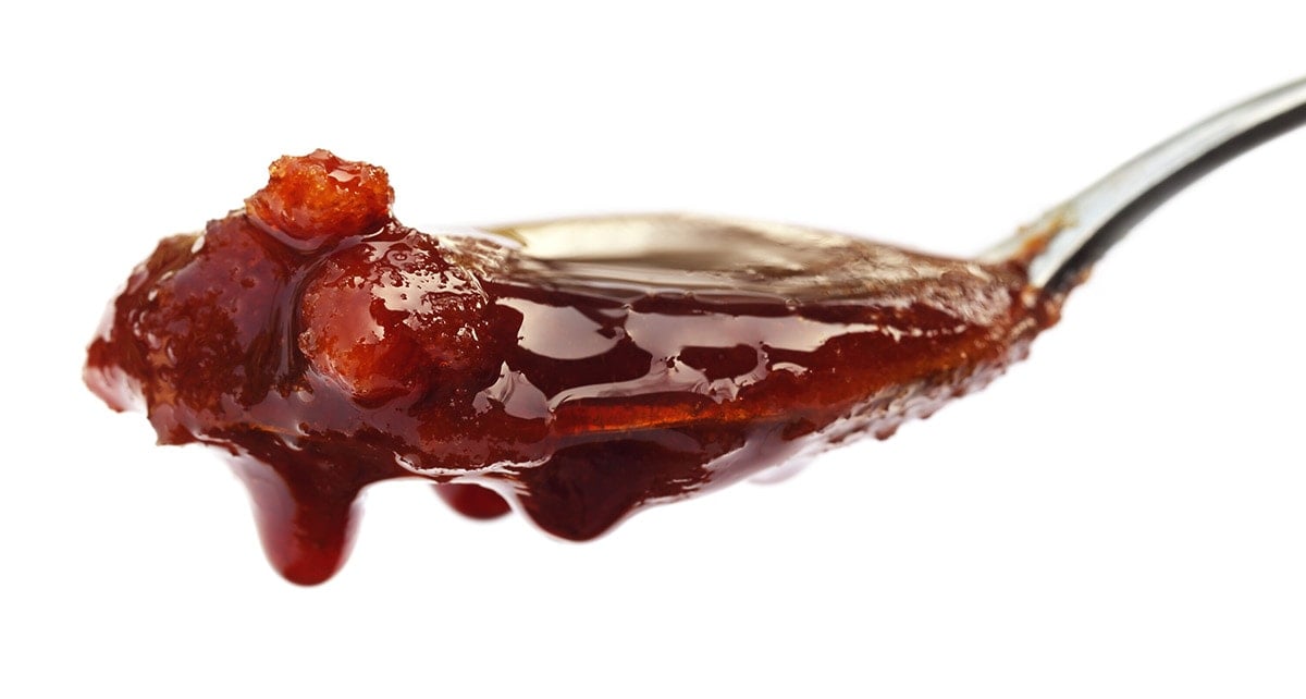 date syrup on white background