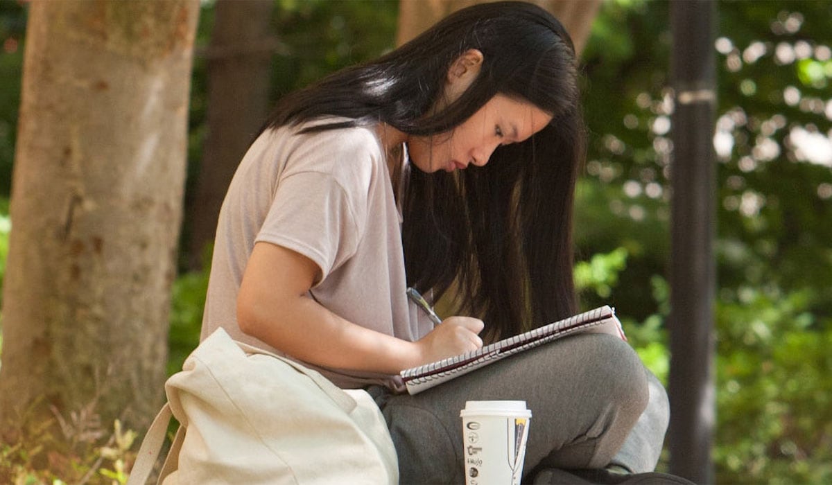 Woman writing in a notepad