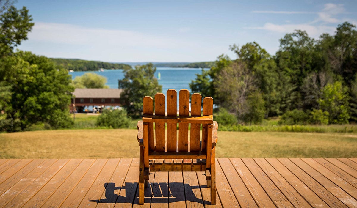 Adirondack chair facing Walloon Lake at Camp Michigania