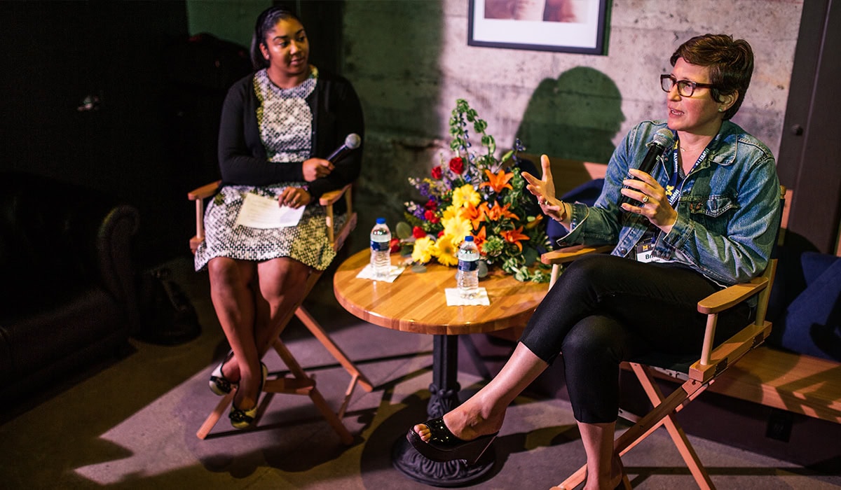 Two women talking at an event