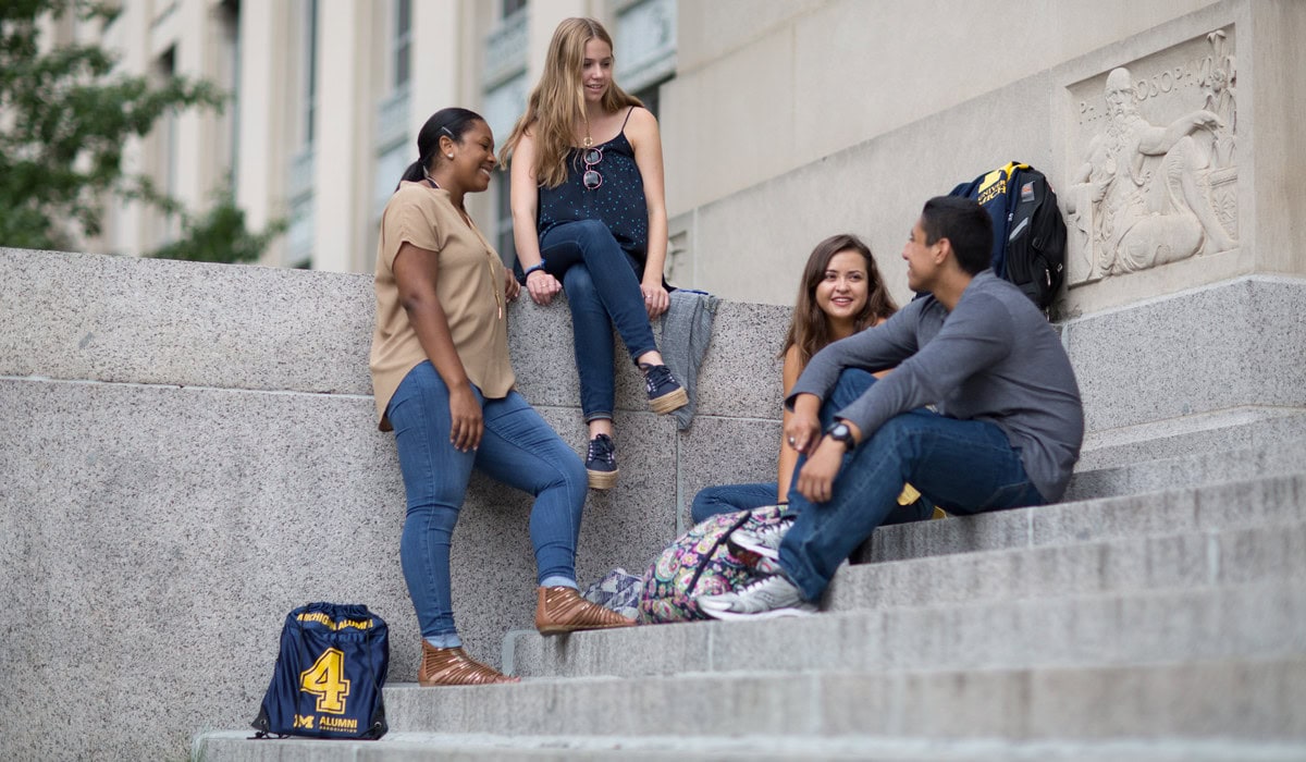 LEAD Scholars talking on the steps of Angell Hall at the University of Michigan