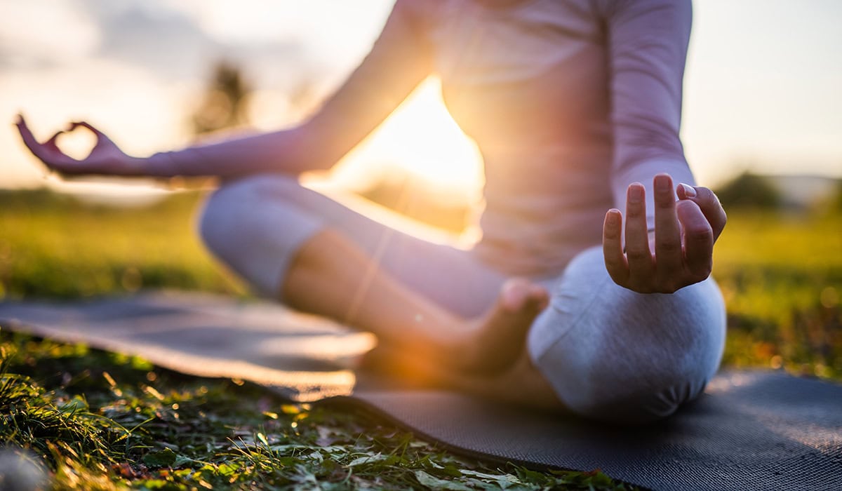 Close Up Of Meditation In Park At Sunrise.