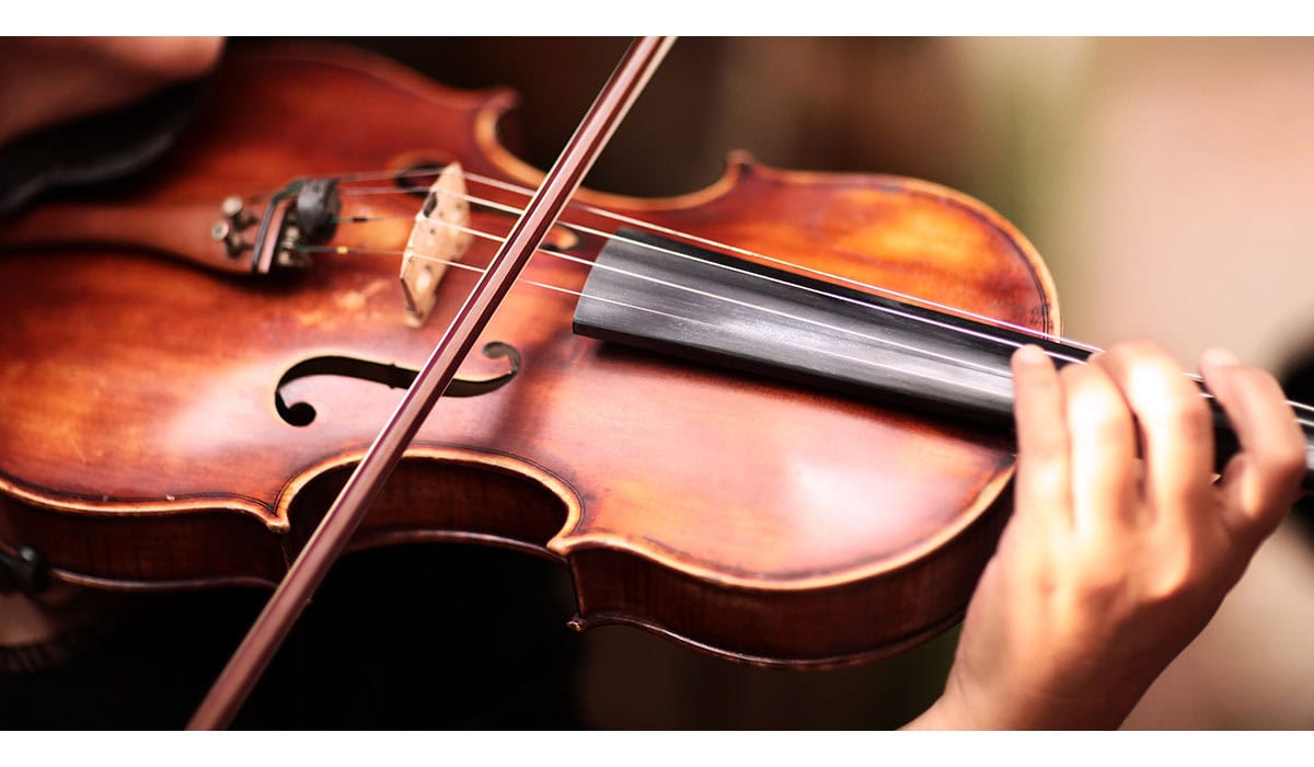 A Person Playing The Violin Showing Hands Holding The Bow