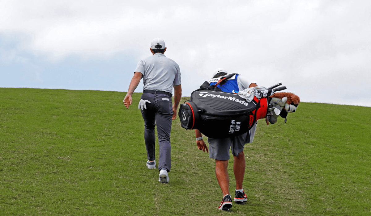 Caddie carrying golf clubs