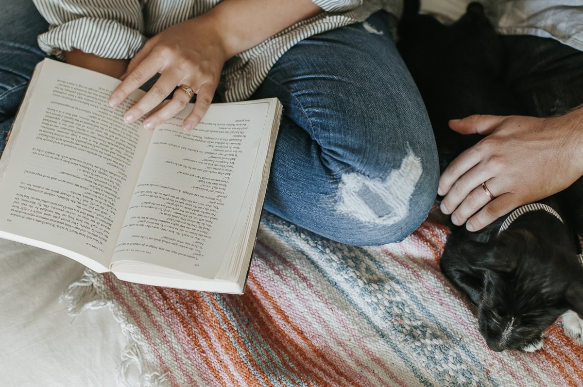 A couple sitting together reading the best marriage books.