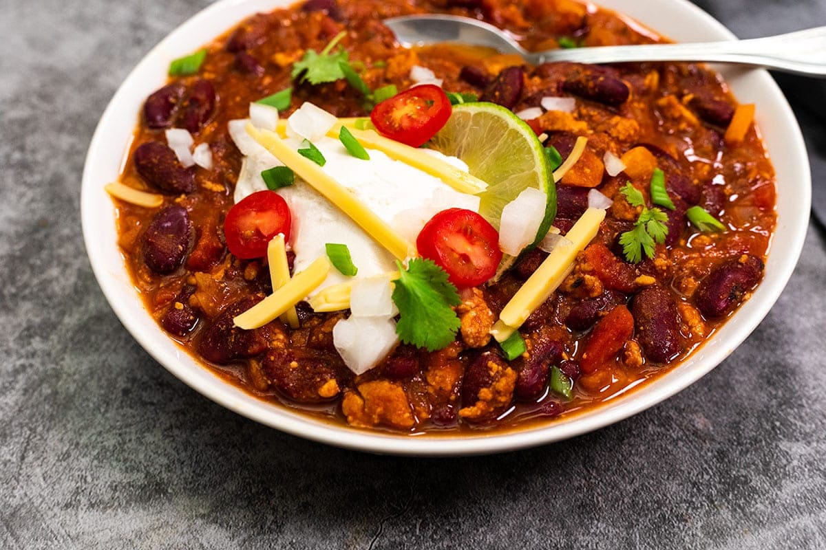 close up view of vegan chili in a white bowl